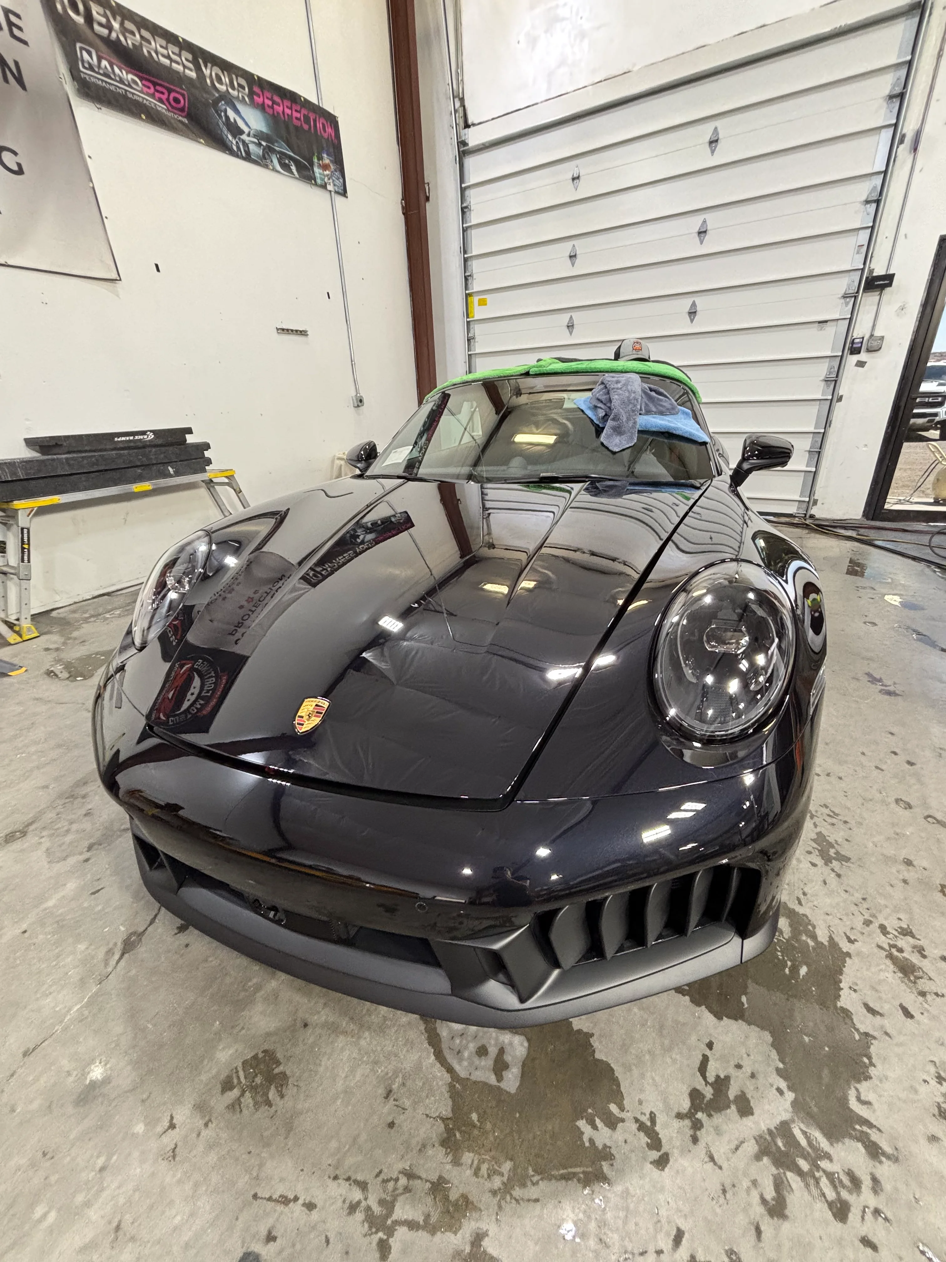 Front view of a sleek black Porsche 911 GT3 RS receiving professional PPF installation at a St. George tint shop.