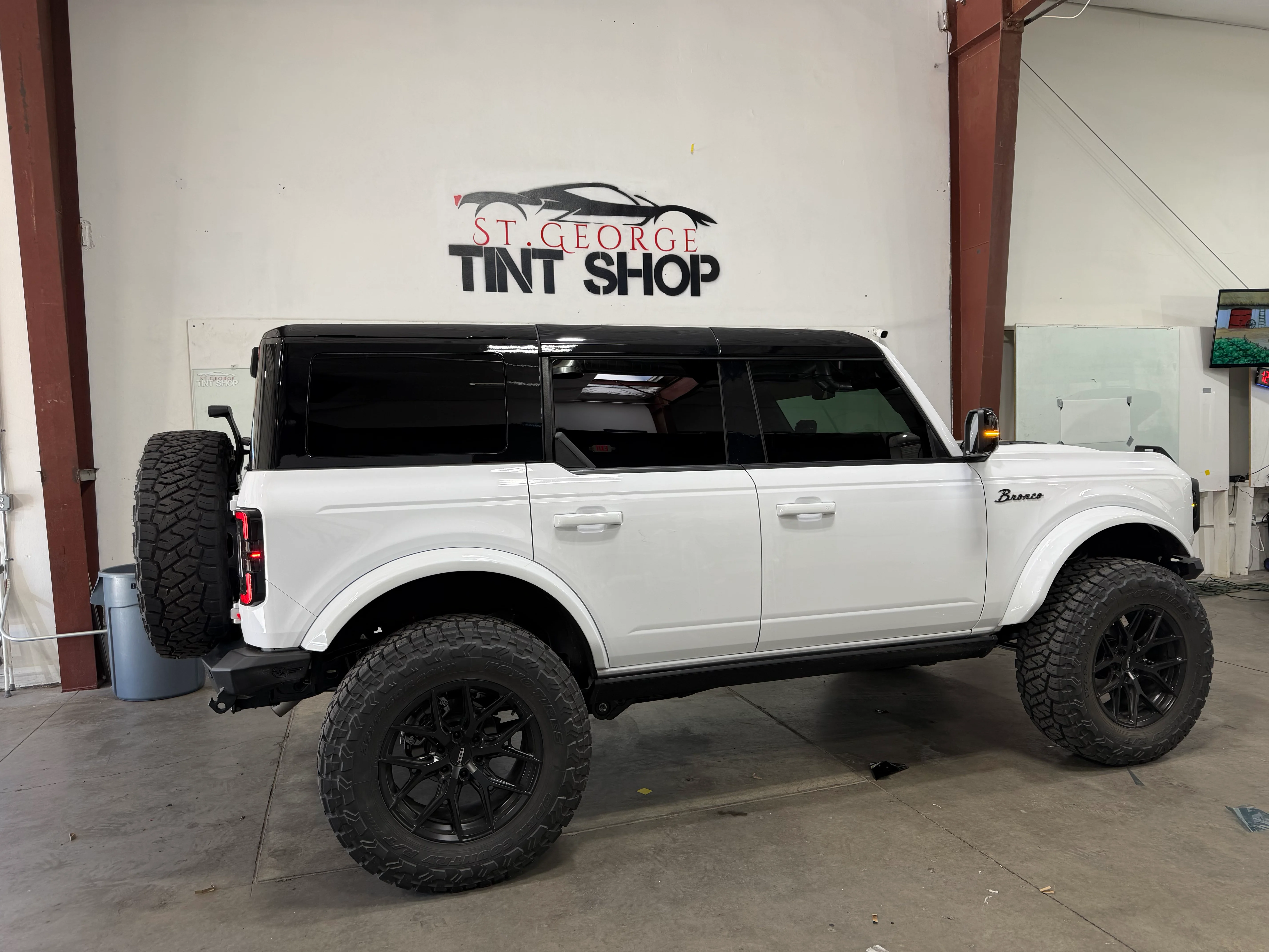 White Ford Bronco SUV with dark ceramic window tint applied, showcasing professional installation at St. George Tint Shop.
