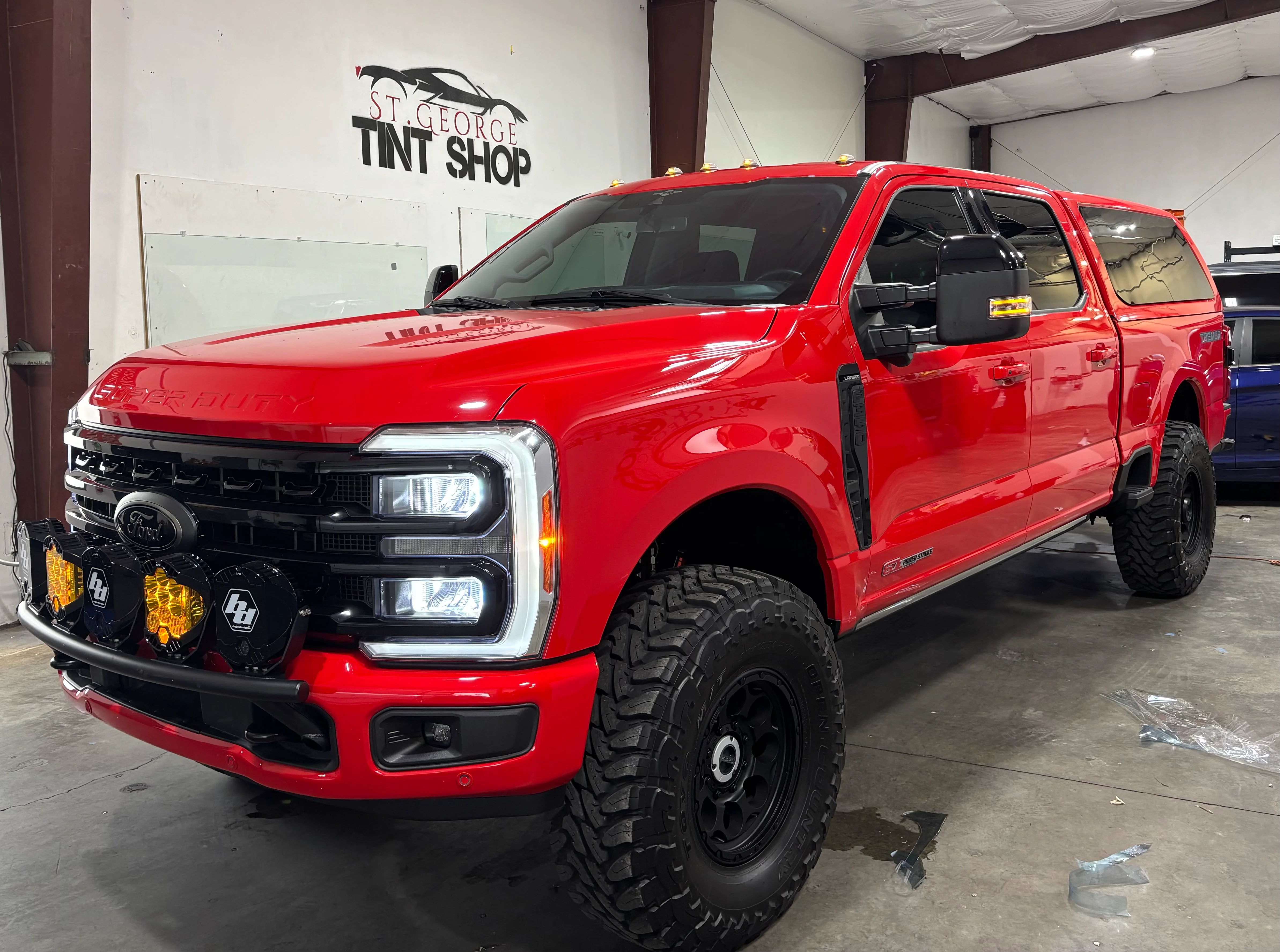 Red Ford F-250 truck with standard window tint in Southern Utah