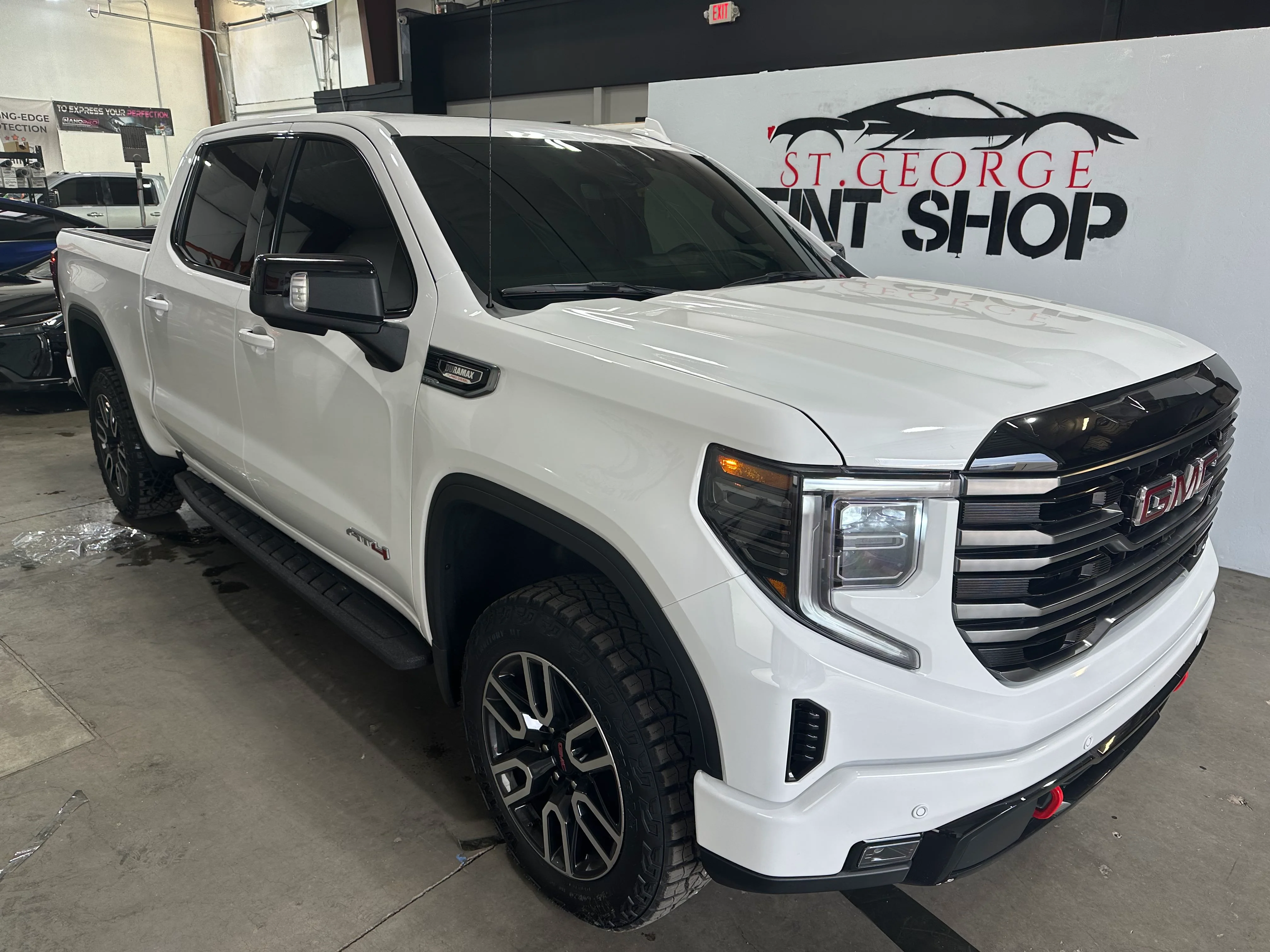 White GMC Sierra AT4 pickup truck with dark ceramic window tint professionally installed at St. George Tint Shop.