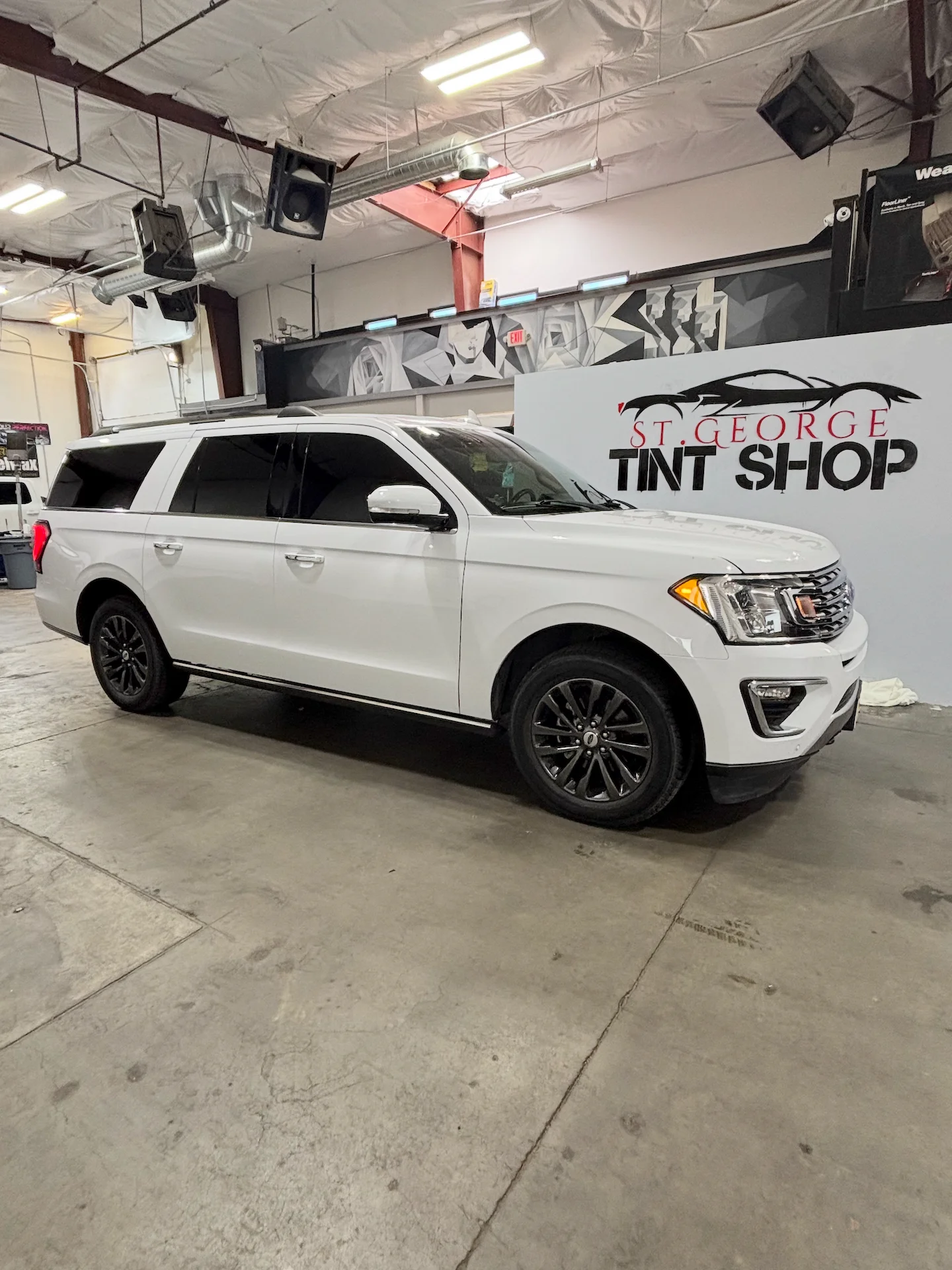 A white Ford Expedition SUV with dark ceramic window tint professionally installed at St. George Tint Shop.