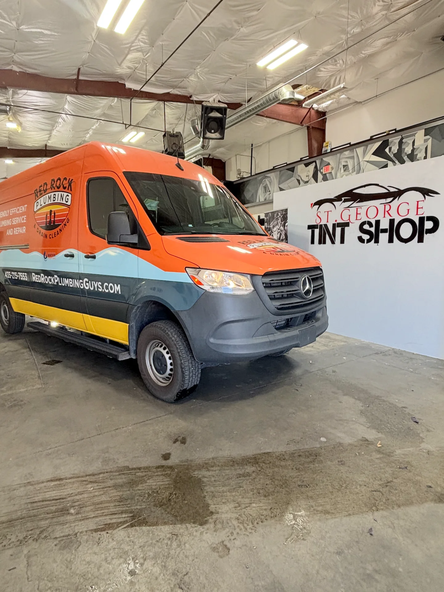 Orange Mercedes Sprinter van with professionally installed window tint at a St. George tint shop. High-quality ceramic film for commercial vehicles in Southern Utah.