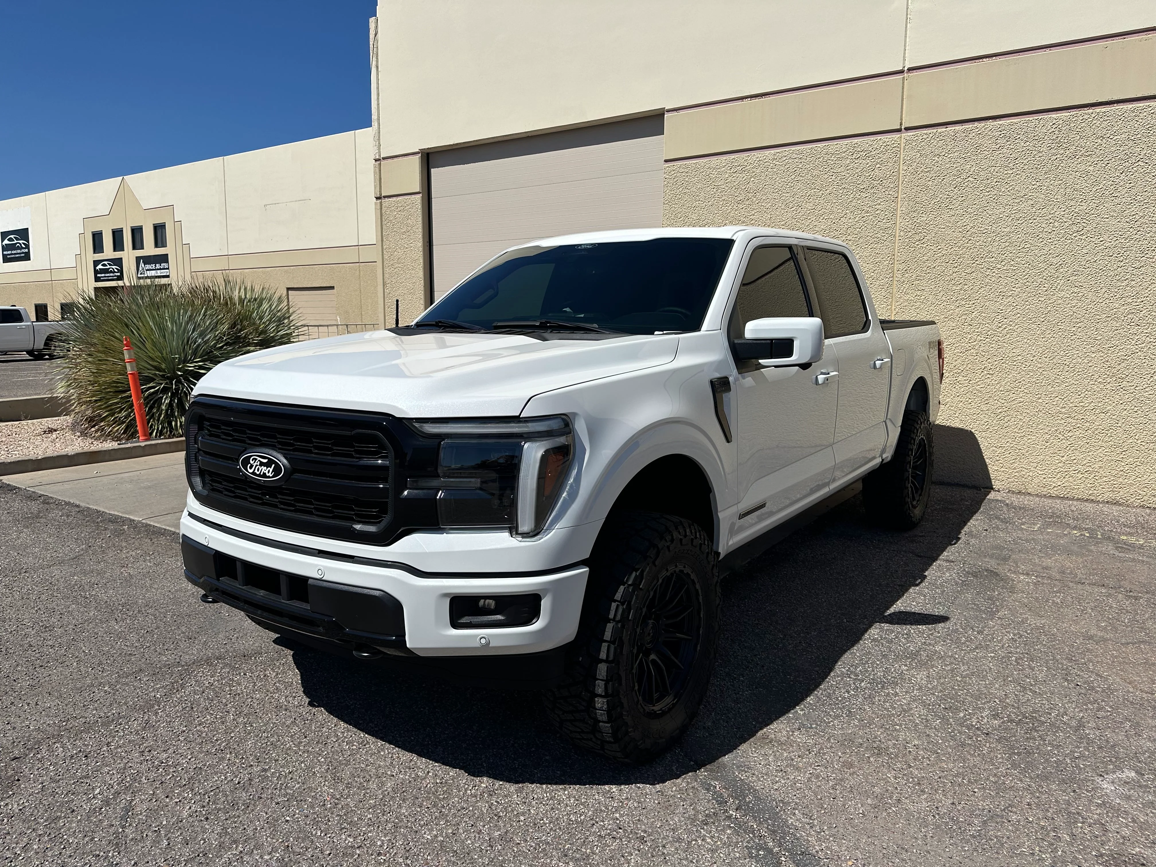 White Ford F-150 truck with dark ceramic window tint professionally installed in St. George, Utah.